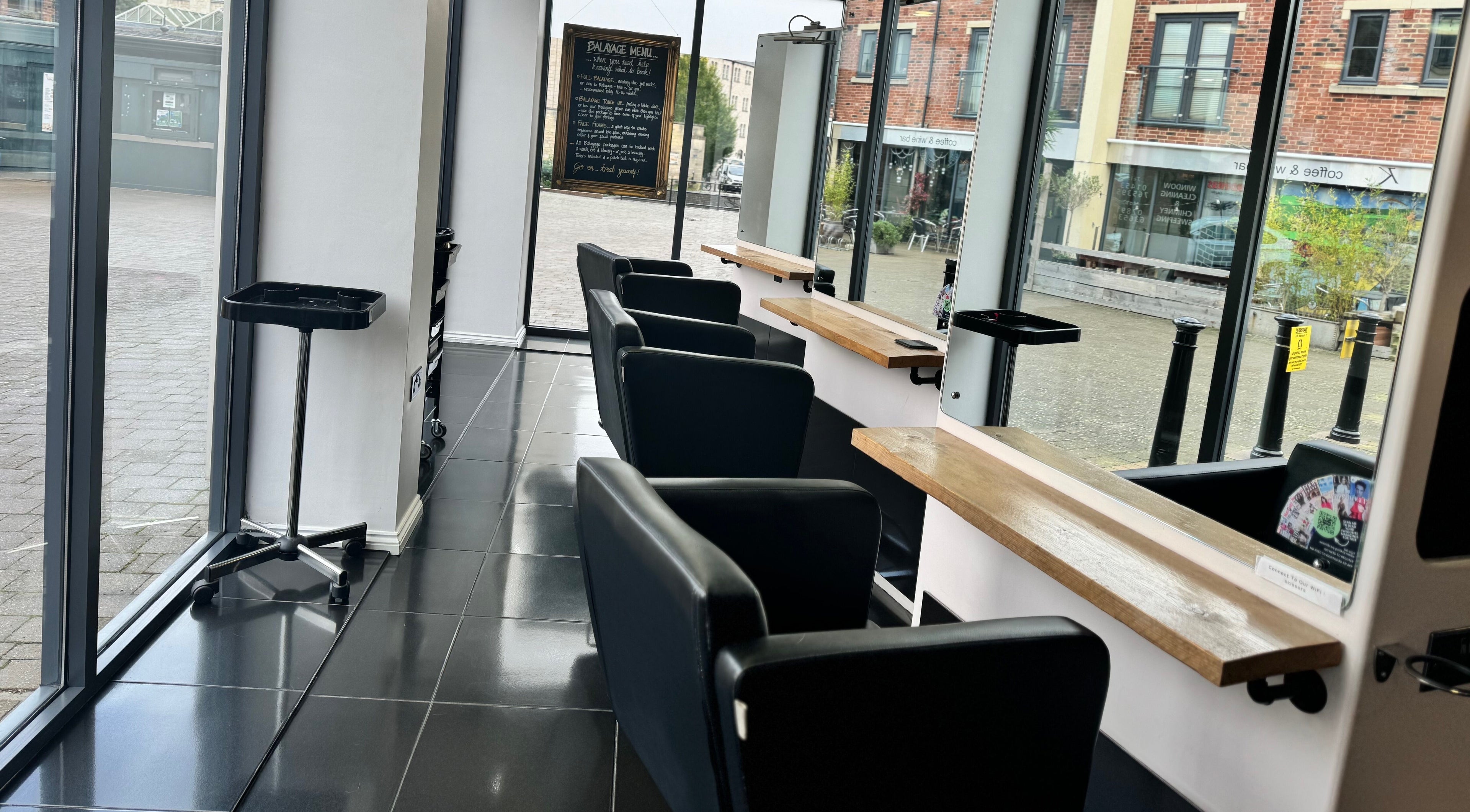 Chic interior of Studio 13 “A Salon Collective for Independent Stylists“, Ebley, England, GB with elegant salon chairs.
