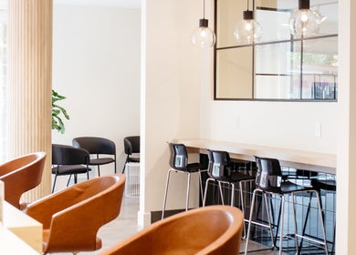 Élégant espace intérieur de Salon KANVA à Boisbriand, Québec, CA, avec sièges modernes et luminaires.