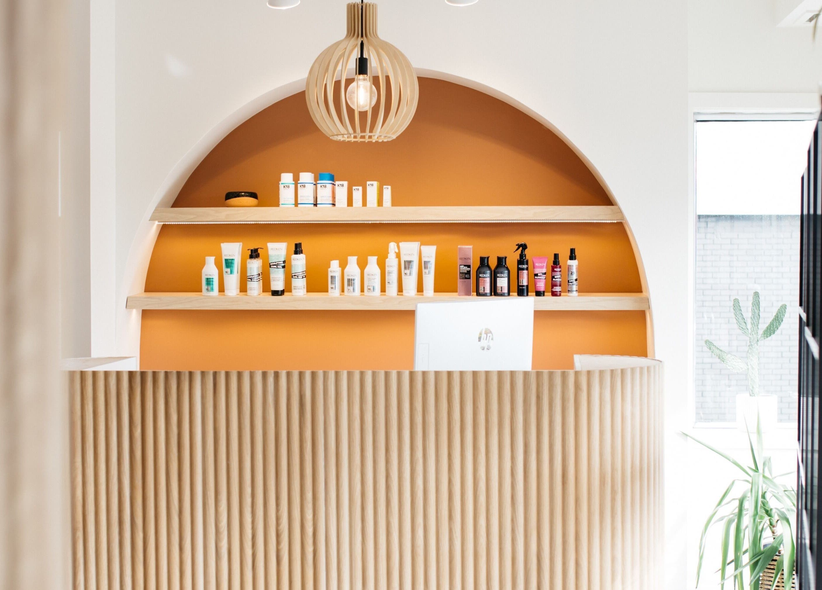 Réception moderne avec étagères au Salon KANVA, Boisbriand, Québec, CA, offrant une ambiance accueillante.