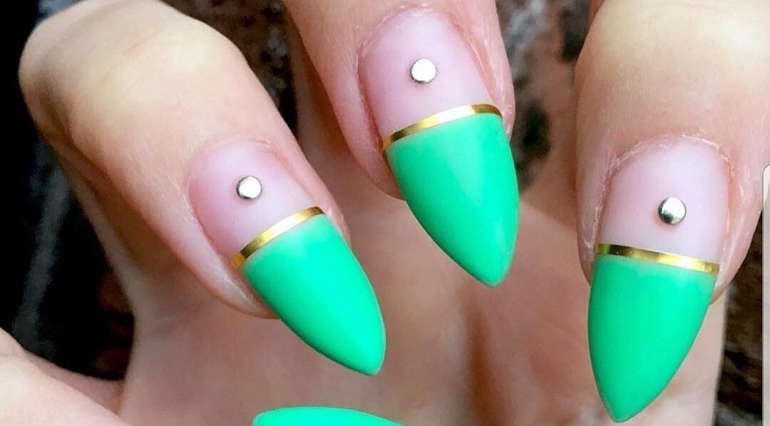 Stunning emerald nail art at Polished, Ripley, England, GB. Features gold accents and rhinestones.