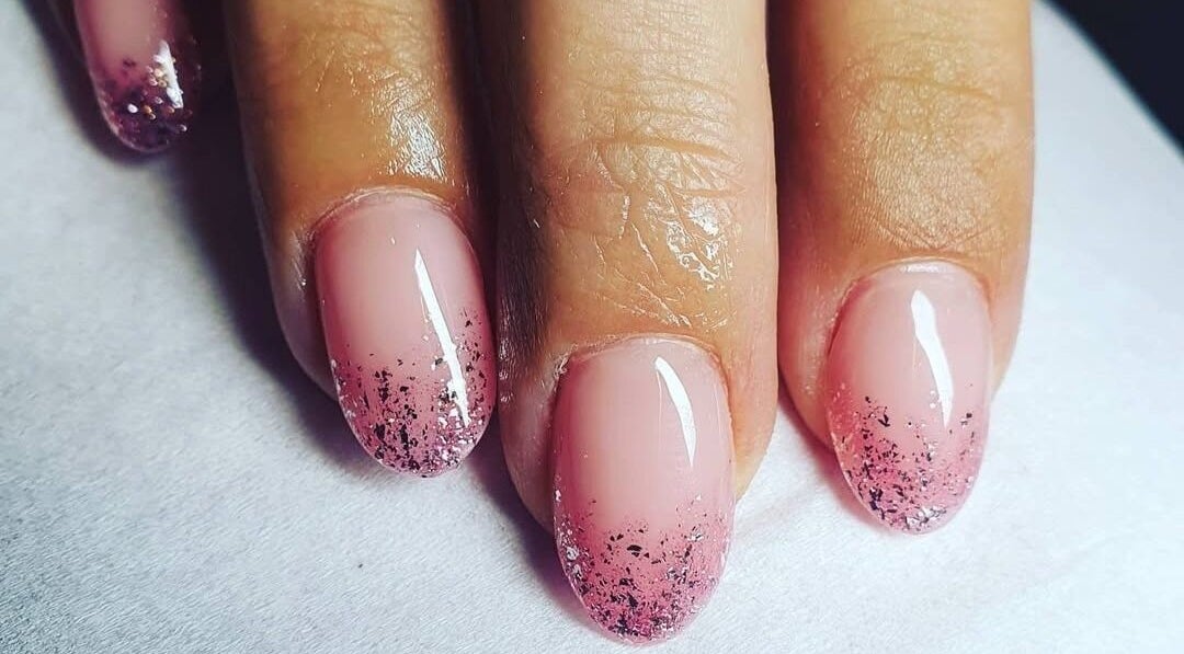 Elegant pink nails with glitter tips at Polished, Ripley, England, GB, showcasing nail artistry.