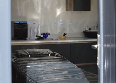 Tranquil therapy room at Next Gen Skin, Stoke-on-Trent, England, GB with massage table and skincare products.