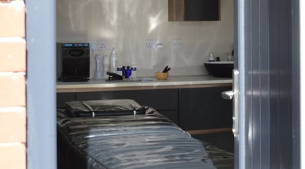 Tranquil therapy room at Next Gen Skin, Stoke-on-Trent, England, GB with massage table and skincare products.