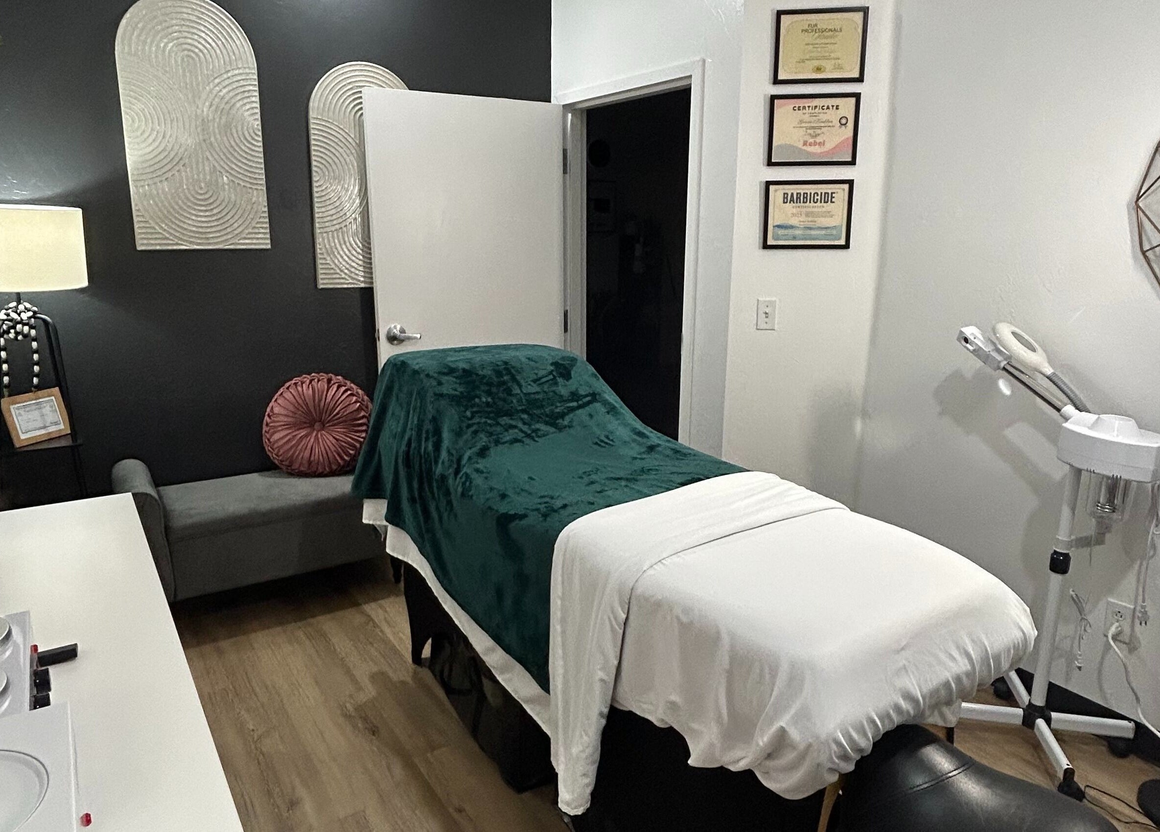 TruRadiance Esthetics treatment room in Piedmont, Oklahoma, US features a cozy massage table and decor.