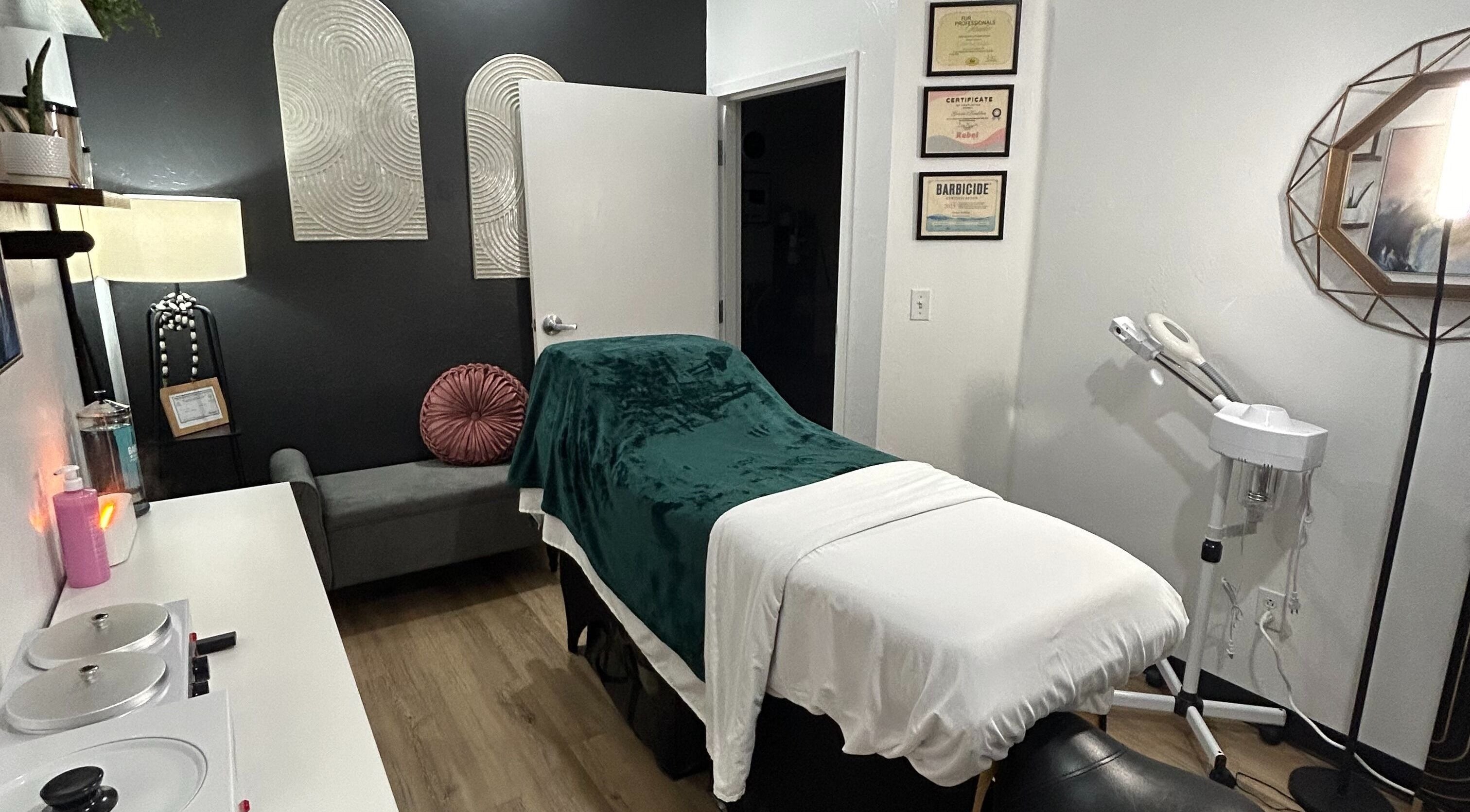 TruRadiance Esthetics treatment room in Piedmont, Oklahoma, US features a cozy massage table and decor.