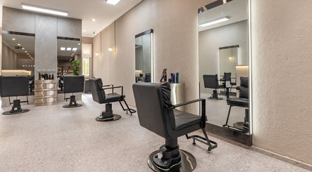 Modern styling chairs at Deevo Hair Salon, Melbourne, Victoria, AU, showcasing sleek interior design.