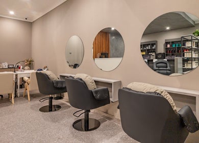 Elegant interior of Deevo Hair Salon in Melbourne, Victoria, AU featuring stylish mirrored stations.