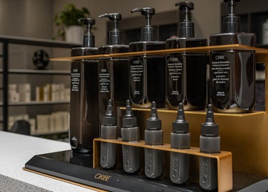 Premium hair care products at Deevo Hair Salon, Melbourne, Victoria, AU, displayed on a modern shelf.