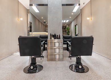 Sleek interior of Deevo Hair Salon in Melbourne, Victoria, showcasing modern styling chairs and elegant decor.