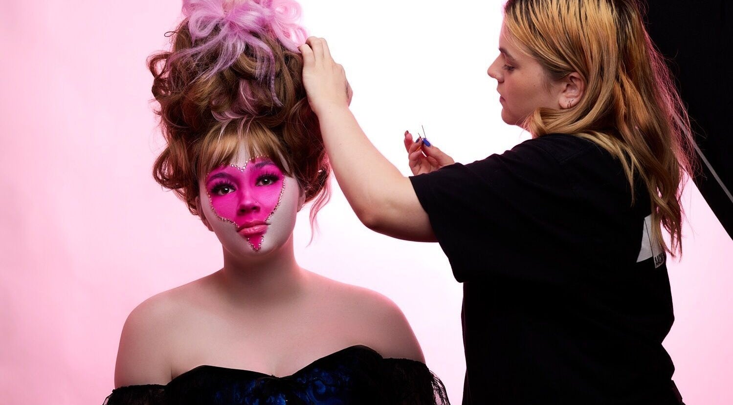 Stylist creating elegant updo with pink makeup theme at HarmonyCrystalHMUA, Morayfield, Queensland, AU.