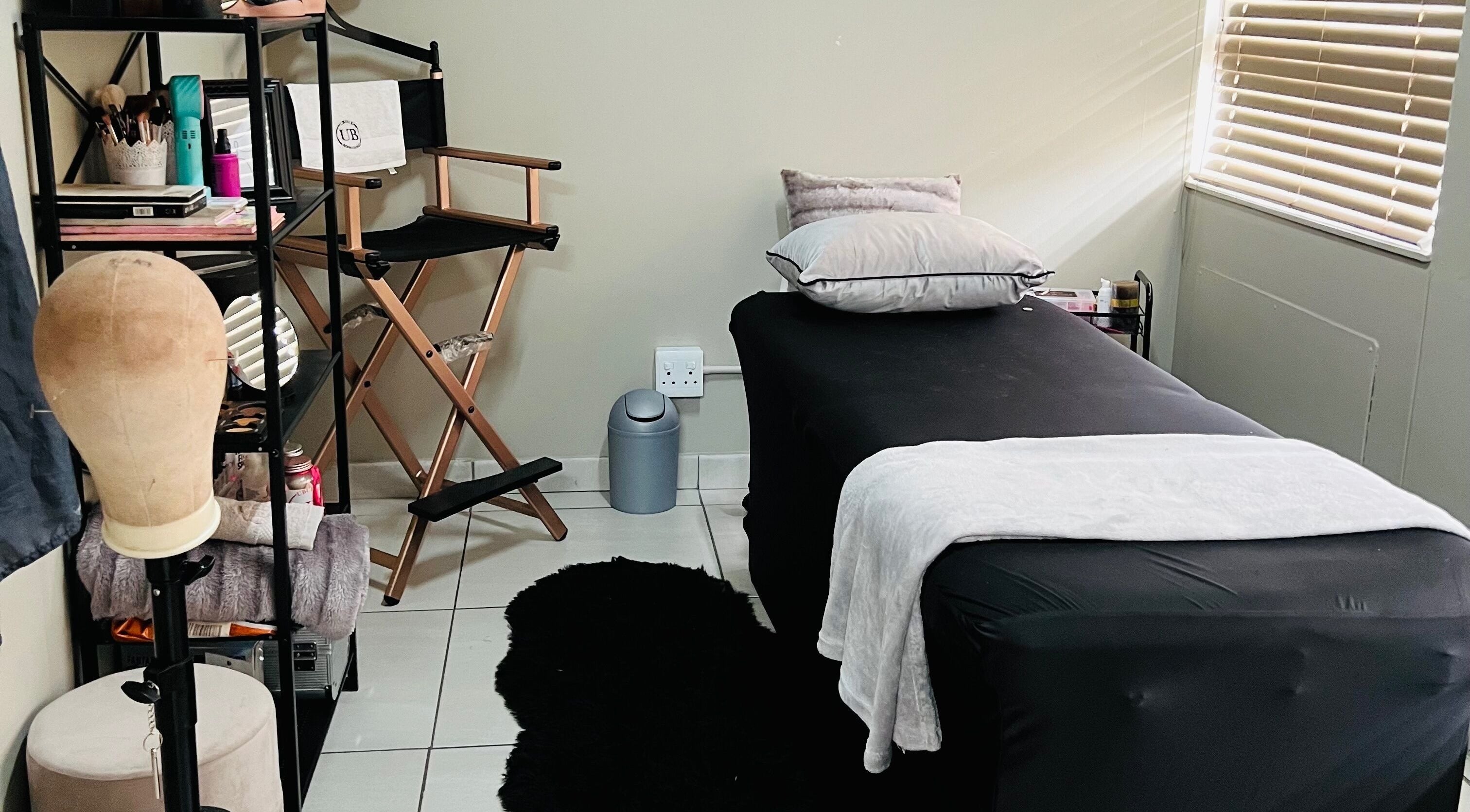 Relaxing treatment room at Ubuhle Bebhudango Beauty Studios, Ga-nala, Mpumalanga, ZA with sleek decor.