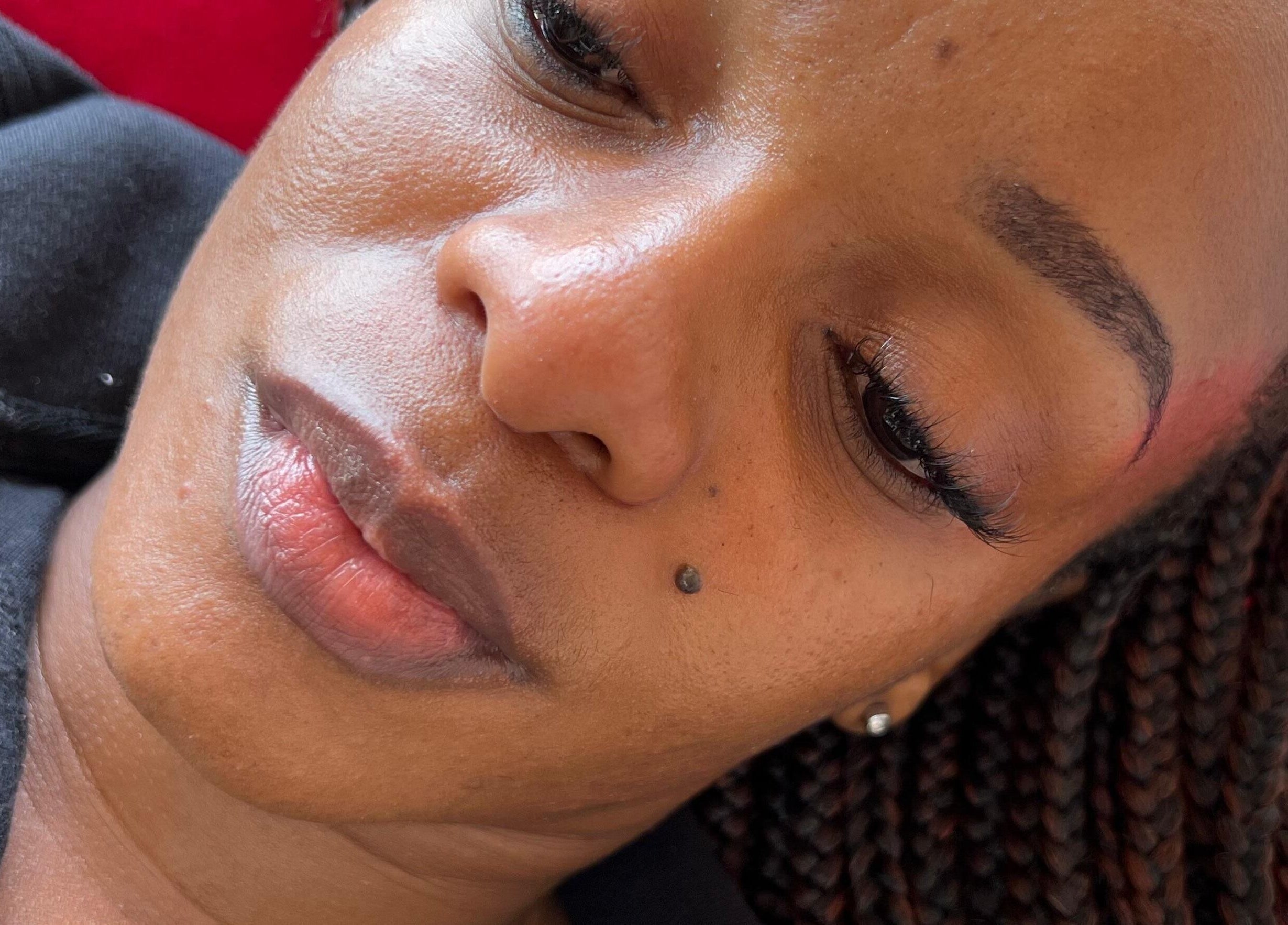 Client with braided hair enjoying beauty treatment at Ubuhle Bebhudango Beauty Studios, Ga-nala, Mpumalanga, ZA.