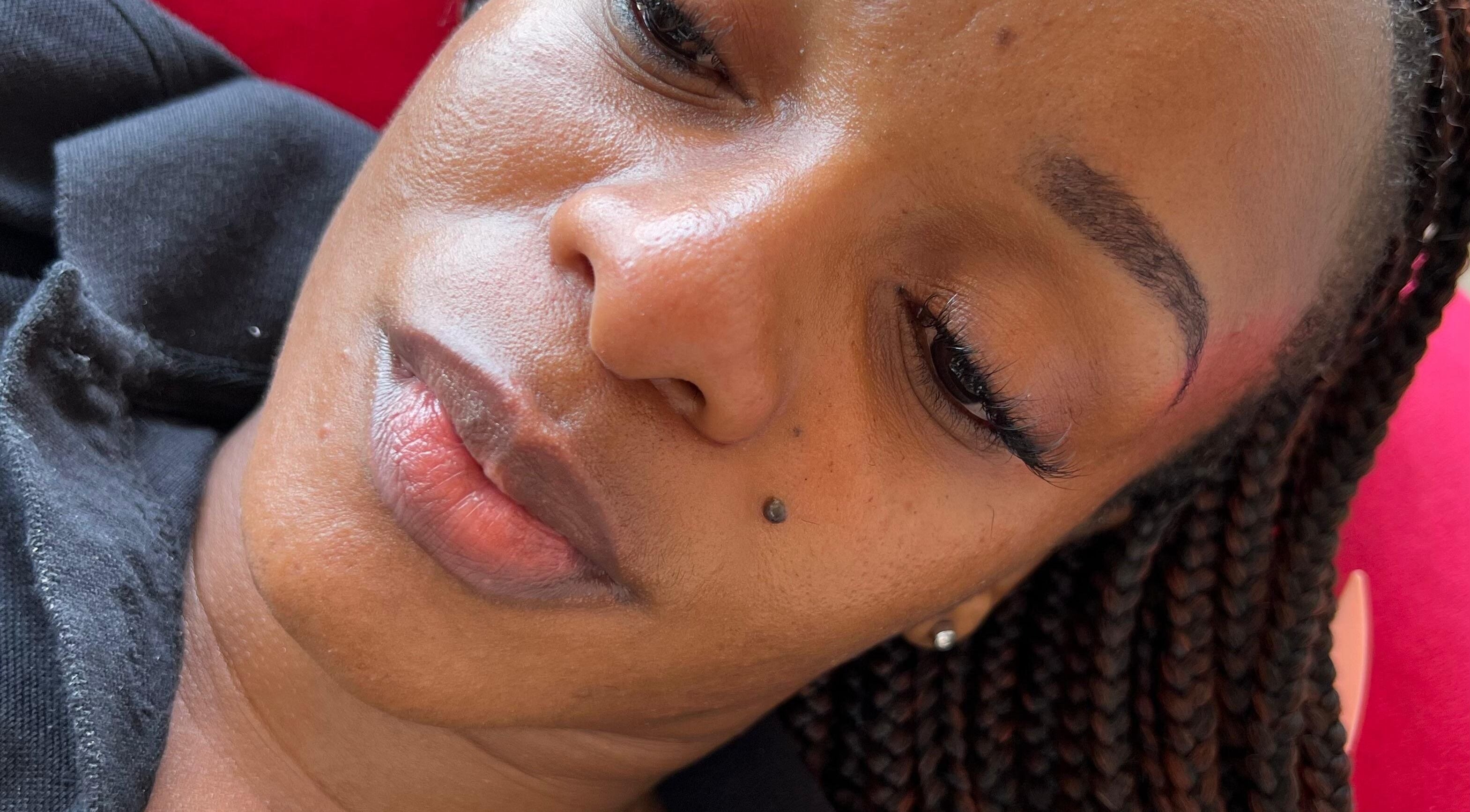 Client with braided hair enjoying beauty treatment at Ubuhle Bebhudango Beauty Studios, Ga-nala, Mpumalanga, ZA.