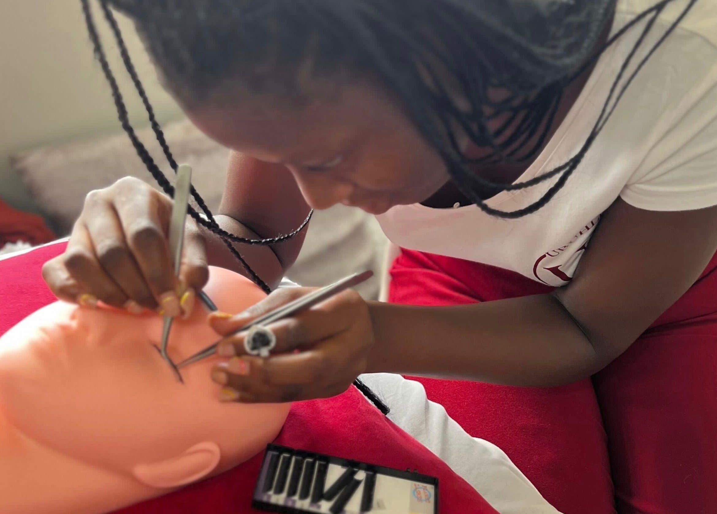 Lash artist at Ubuhle Bebhudango Beauty Studios in Ga-nala, Mpumalanga, ZA, applying lash extensions.