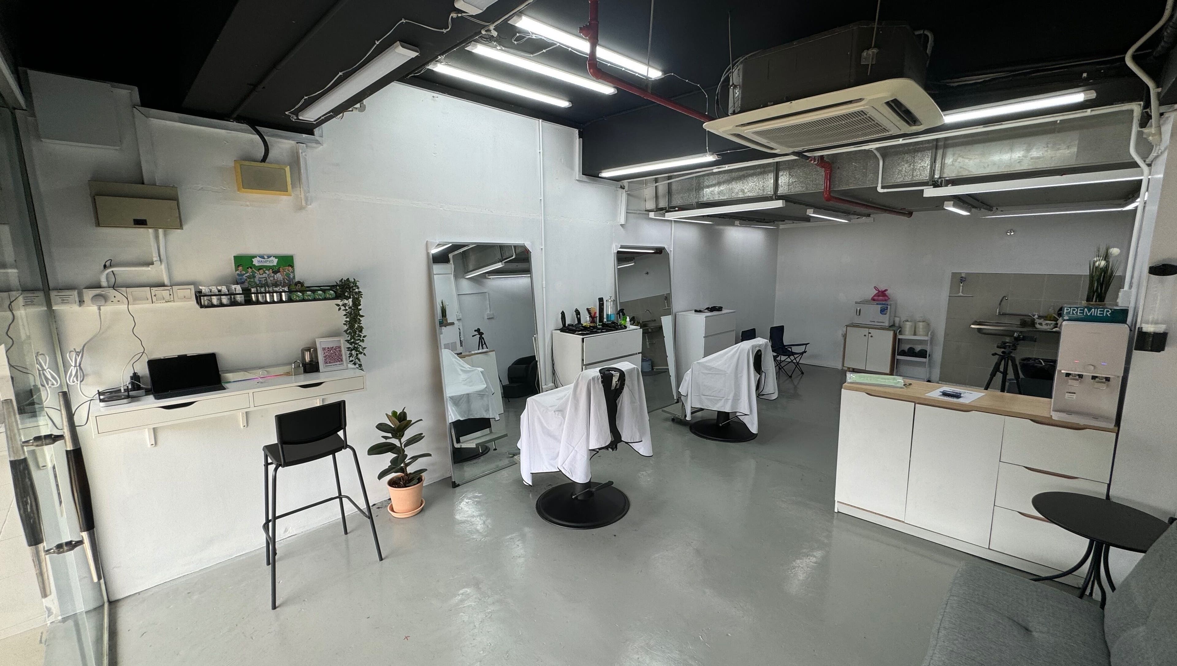 Interior of MENCAVE BARBER STUDIO in Shah Alam, Selangor, MY, featuring sleek chairs and minimalist decor.