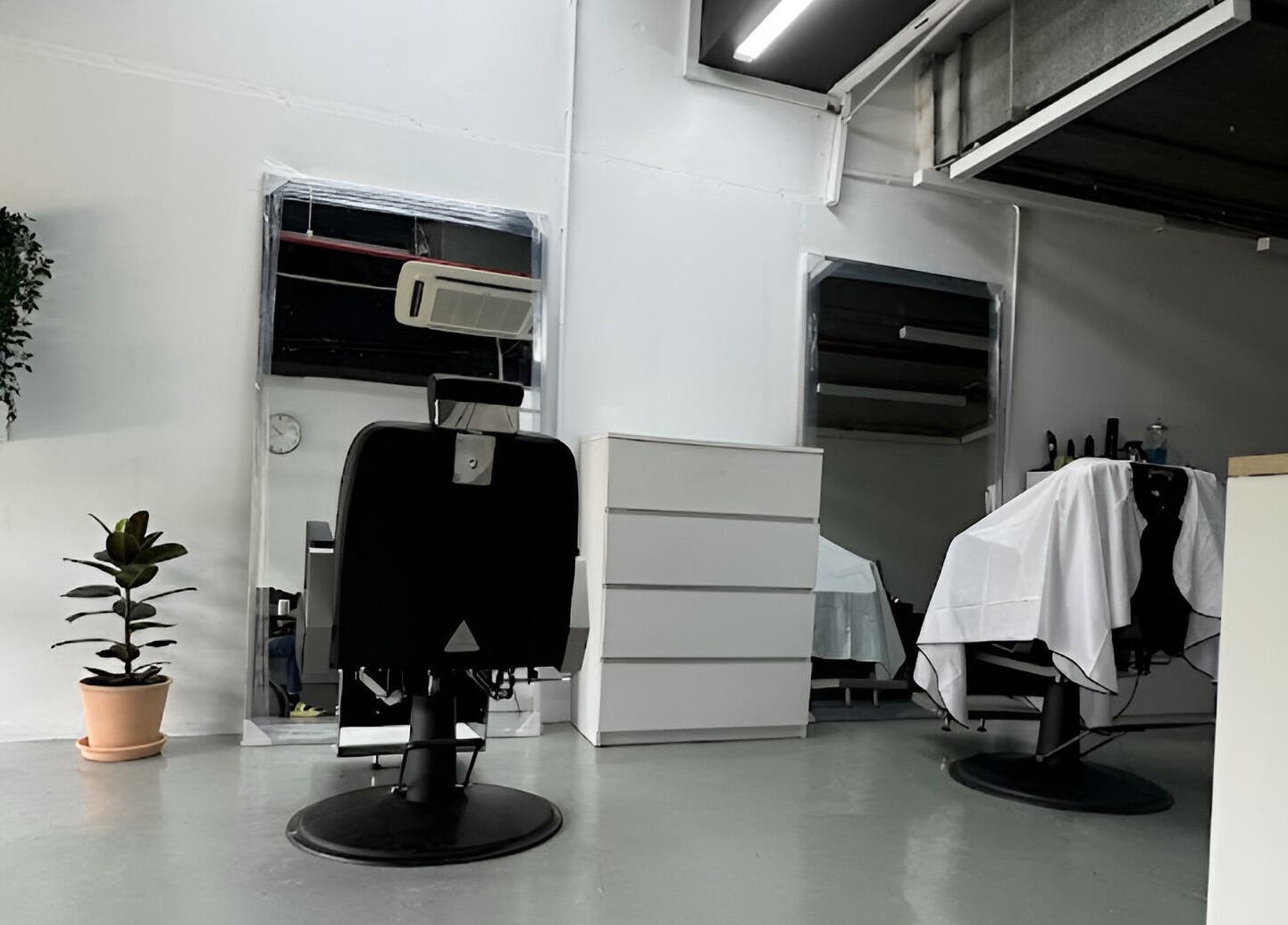 Modern barber chairs at MENCAVE BARBER STUDIO in Shah Alam, Selangor, MY, showcasing contemporary elegance.
