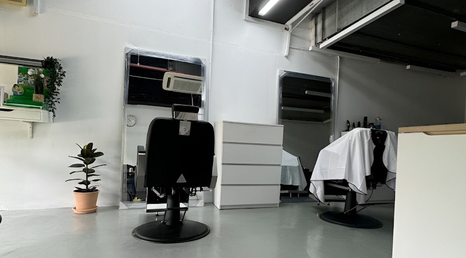 Modern barber chairs at MENCAVE BARBER STUDIO in Shah Alam, Selangor, MY, showcasing contemporary elegance.