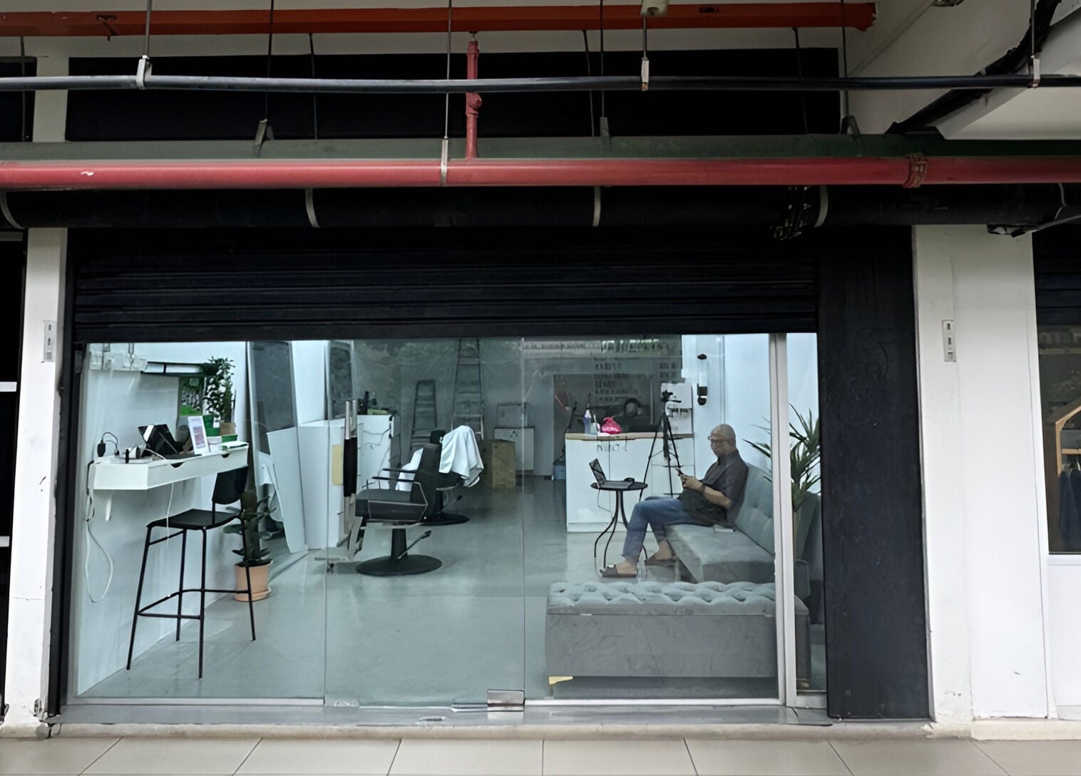 Front view of MENCAVE BARBER STUDIO in Shah Alam, Selangor, MY with a chic interior and seating area.