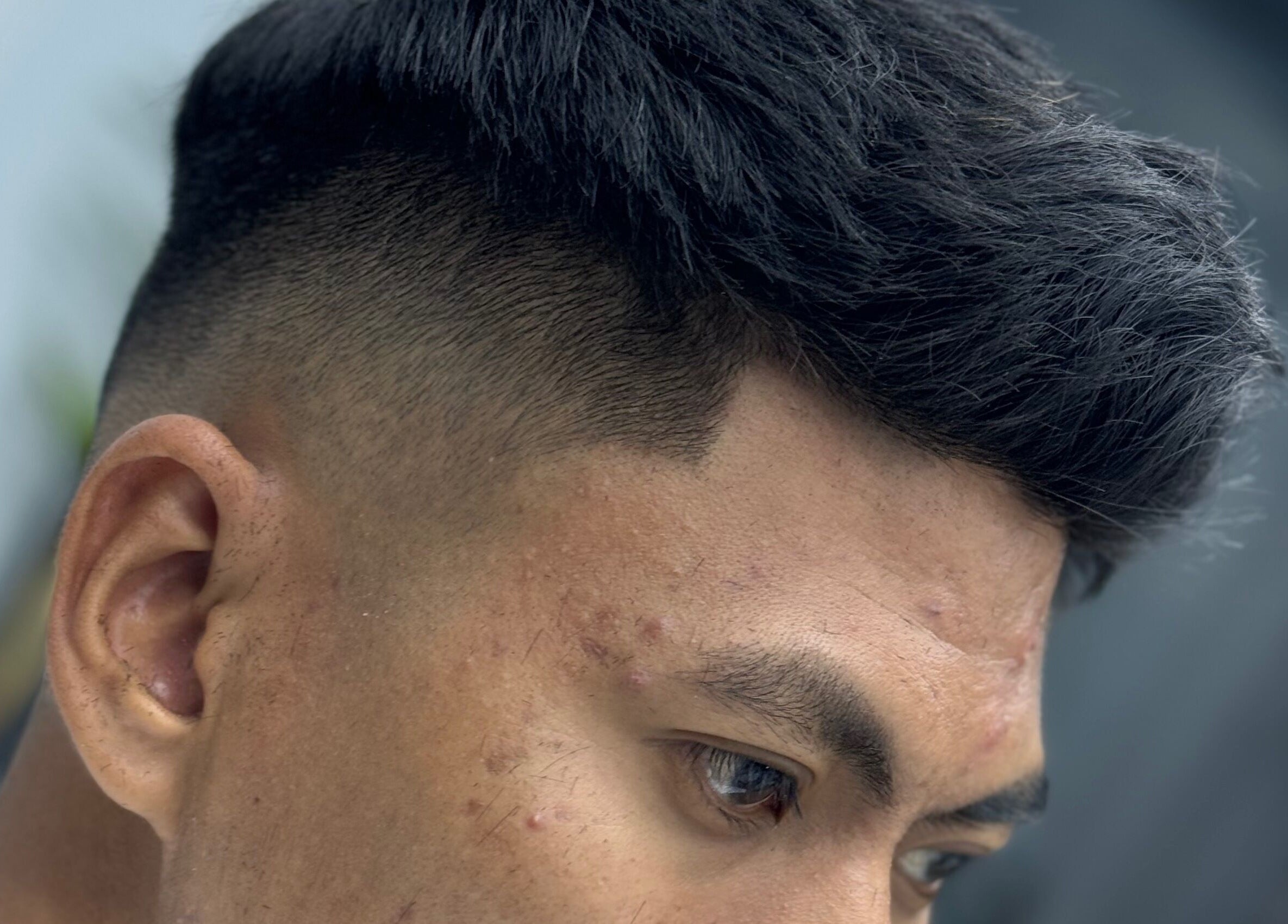 Close-up of a fresh haircut at MENCAVE BARBER STUDIO, Shah Alam, Selangor, MY showcasing a stylish fade.
