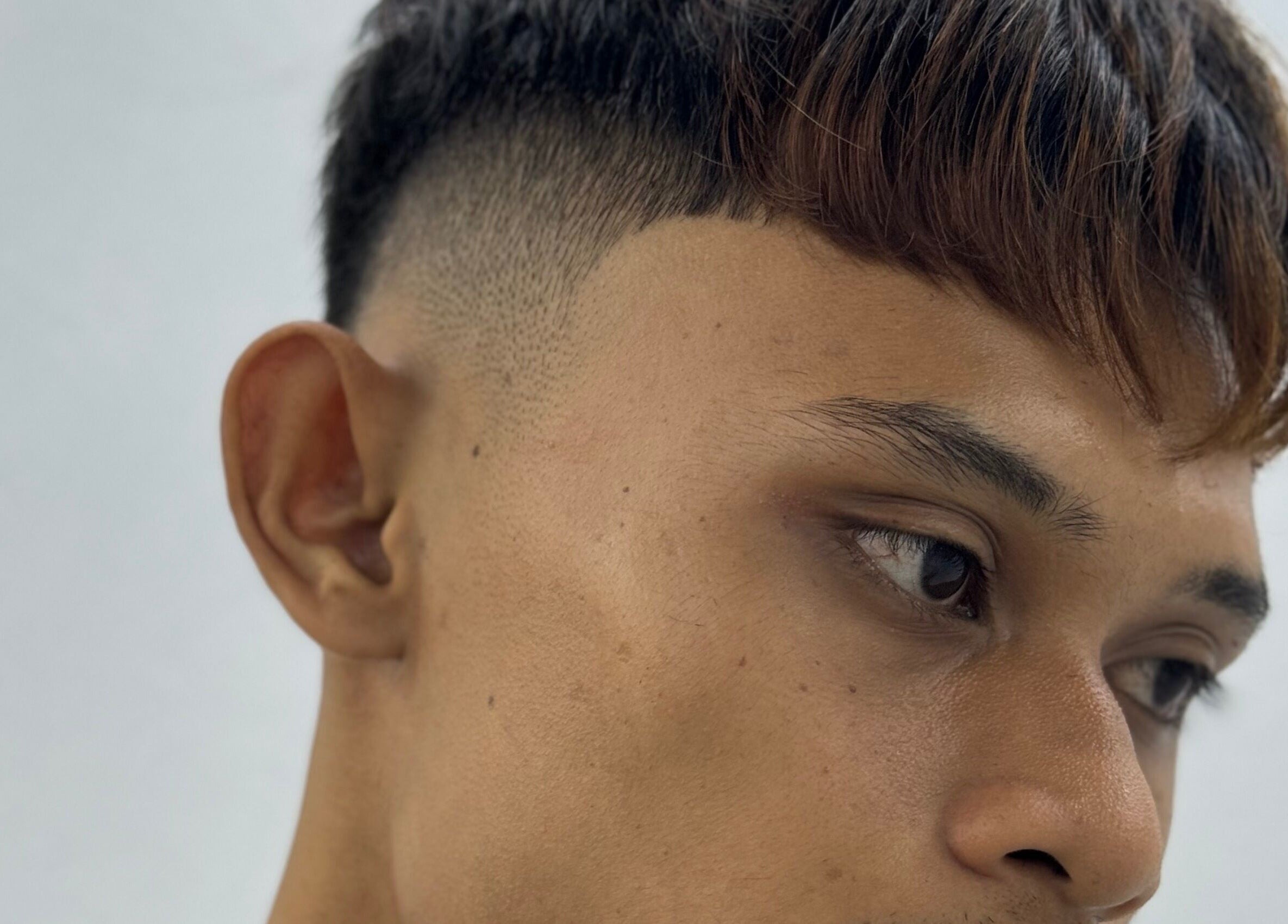 Modern hairstyle at MENCAVE BARBER STUDIO in Shah Alam, Selangor, MY featuring a fresh haircut.