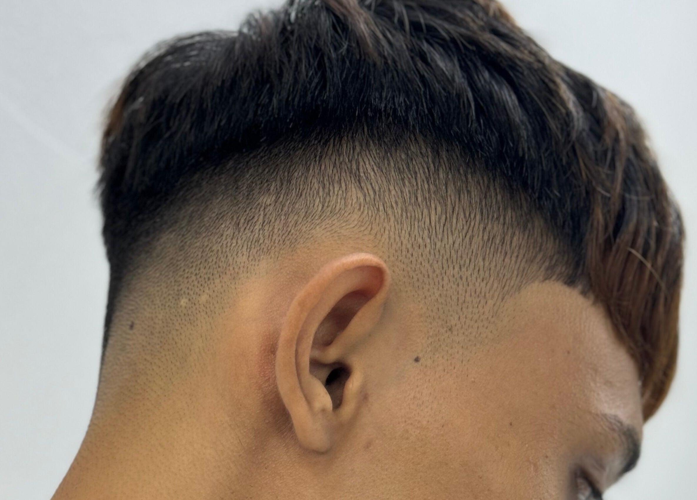 Clean skin fade haircut at MENCAVE BARBER STUDIO in Shah Alam, Selangor, MY.