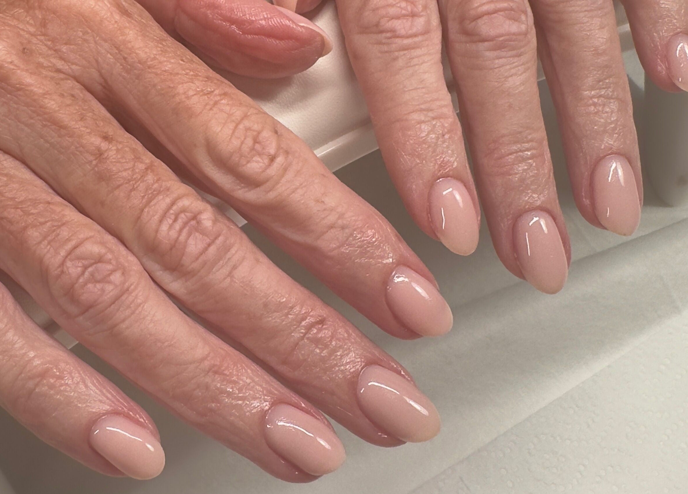 Elegant manicured nails at Summer-Nails in Melbourne, Victoria, AU showcasing a polished nude finish.