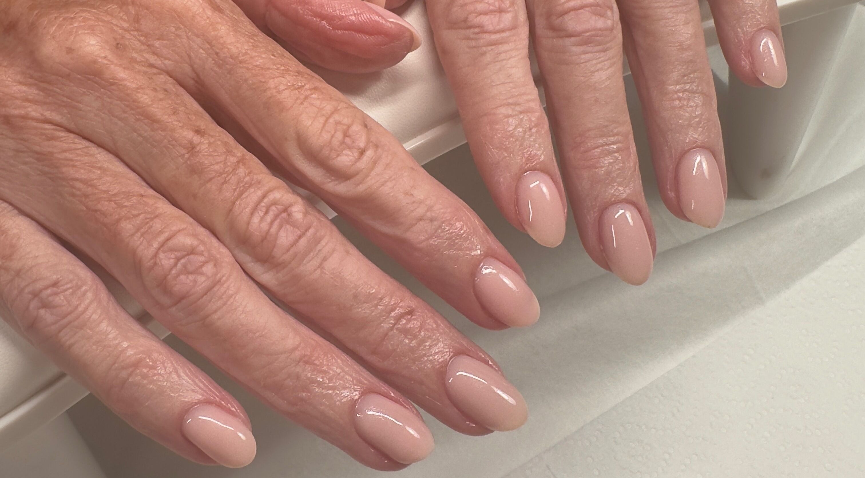 Elegant manicured nails at Summer-Nails in Melbourne, Victoria, AU showcasing a polished nude finish.