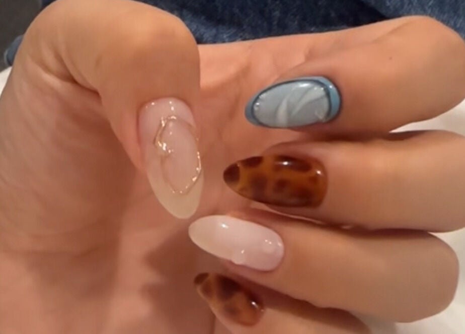 Artistic nail designs showcased at Summer-Nails, Melbourne, Victoria, AU, featuring elegant tortoiseshell patterns.