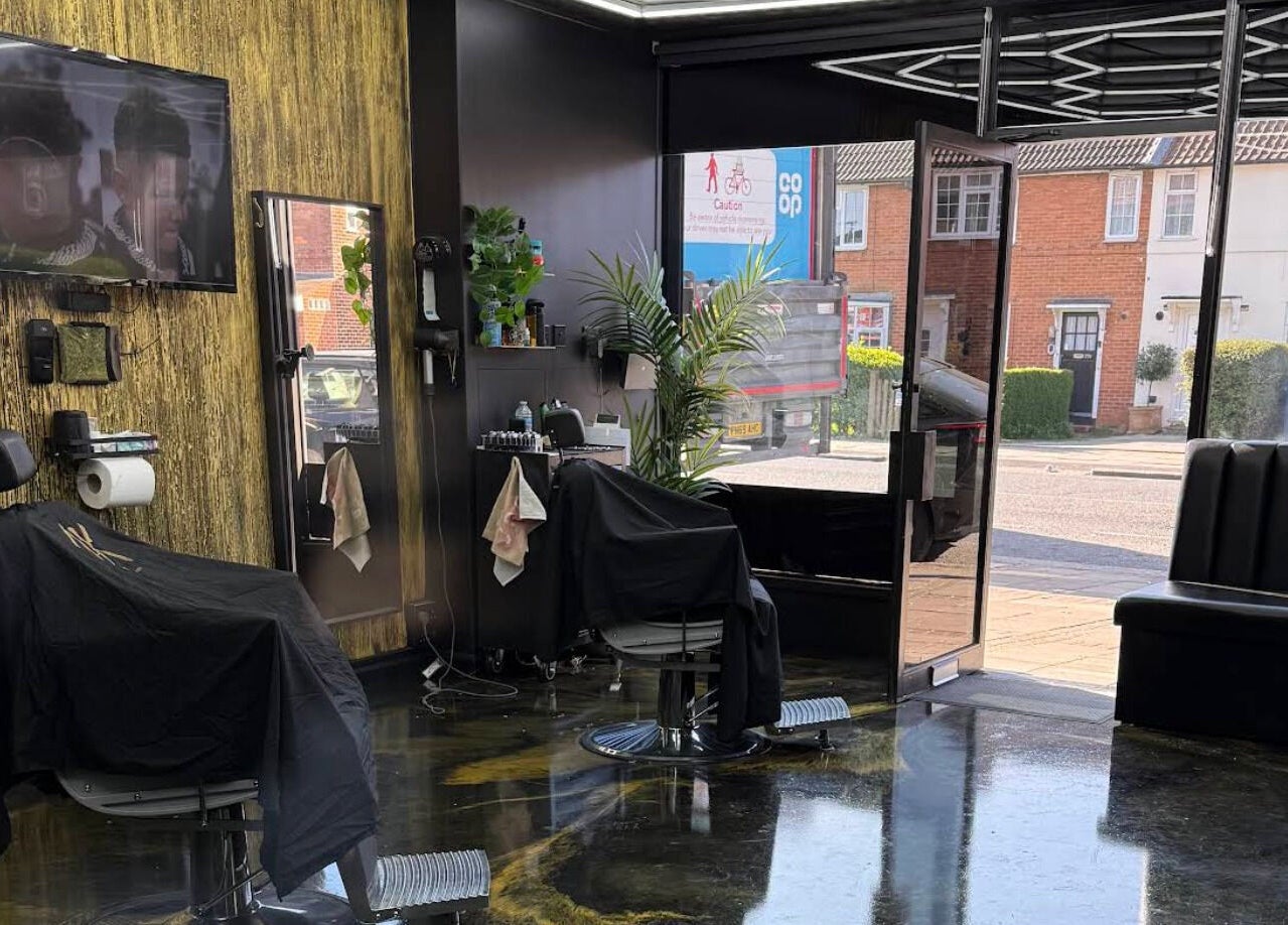 Stylish interior of Jk The Barber Studios Limited in Edgware, England, GB featuring modern barber chairs and decor.