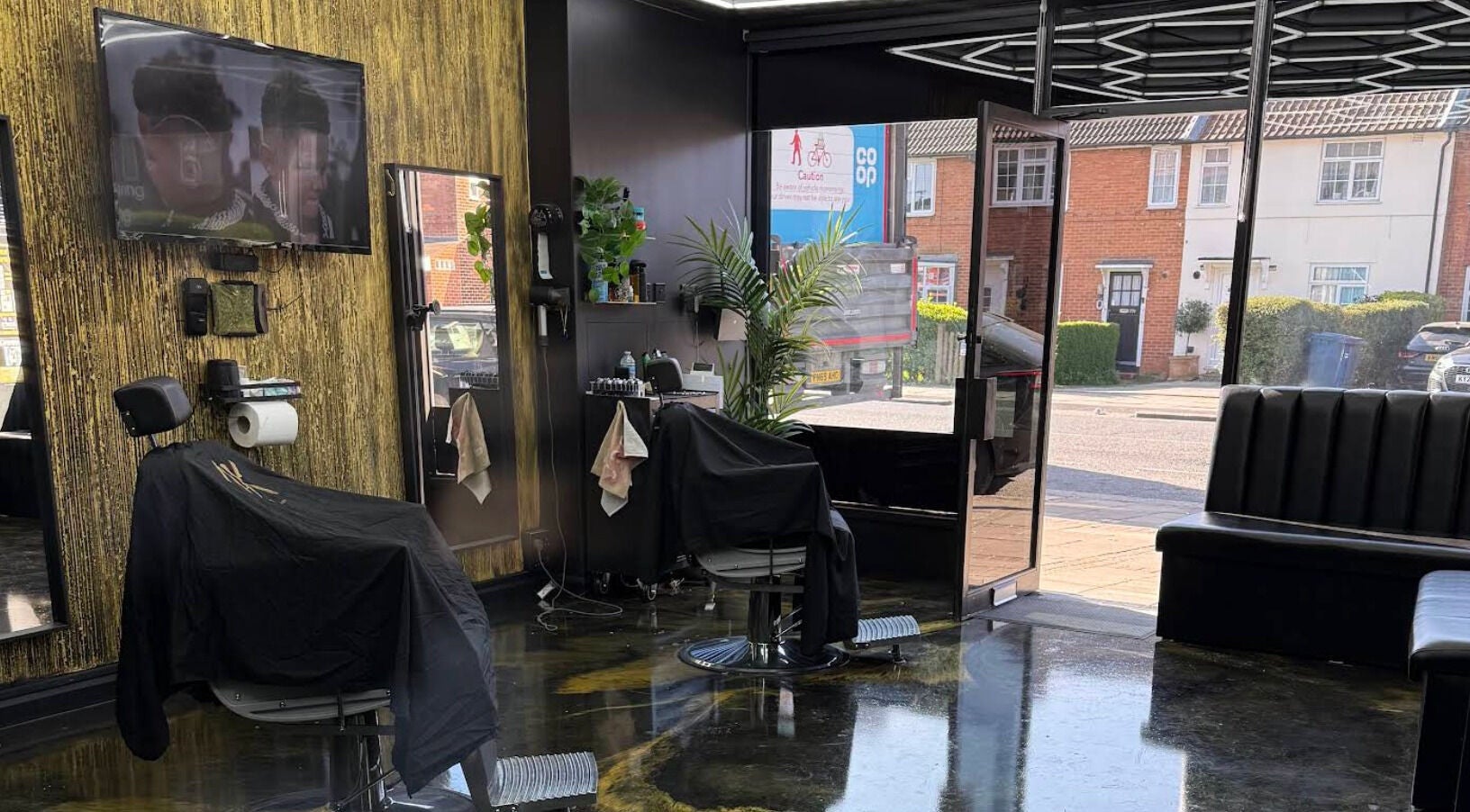Stylish interior of Jk The Barber Studios Limited in Edgware, England, GB featuring modern barber chairs and decor.