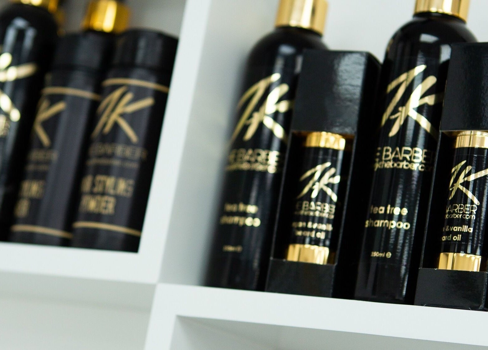Premium hair care products at Jk The Barber Studios Limited, Edgware, England, GB, neatly displayed on shelves.