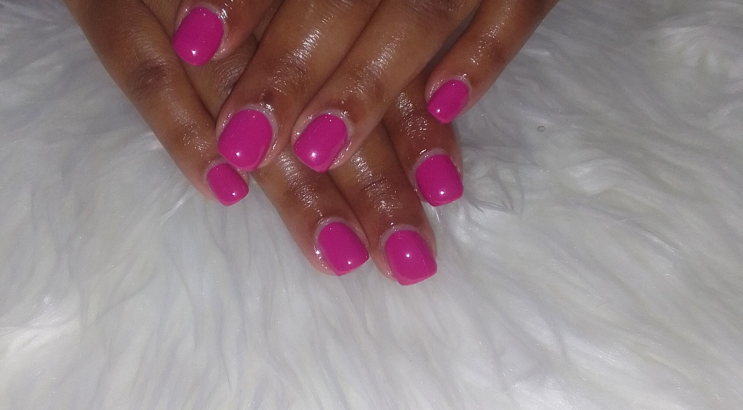 Bright pink manicure at Sharlon Beuti Bar, Cape Town, Western Cape, ZA showcasing elegant hand care.