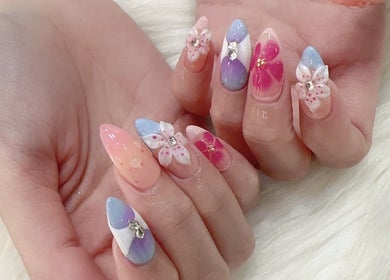 Elegant floral nail art at The Queenz, Singapore, SG, showcasing exquisite craftsmanship and beautiful pastel colors.