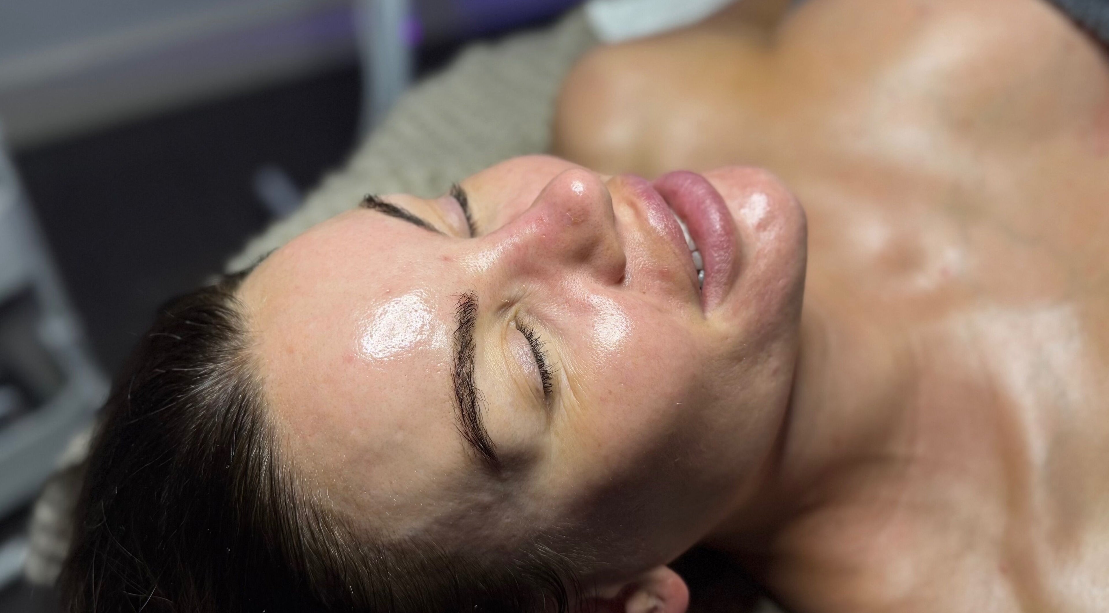 Woman enjoying a facial treatment at The Lash Room in Ayr, Scotland, GB. Her skin looks relaxed and glowing.