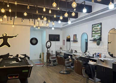 Modern barber interior at Sweeney Todds Barbers, Arjan, Dubai, AE with stylish lighting and decor.