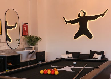 Modern lounge area at Sweeney Todds Barbers, Arjan, Dubai, AE featuring a pool table and stylish decor.