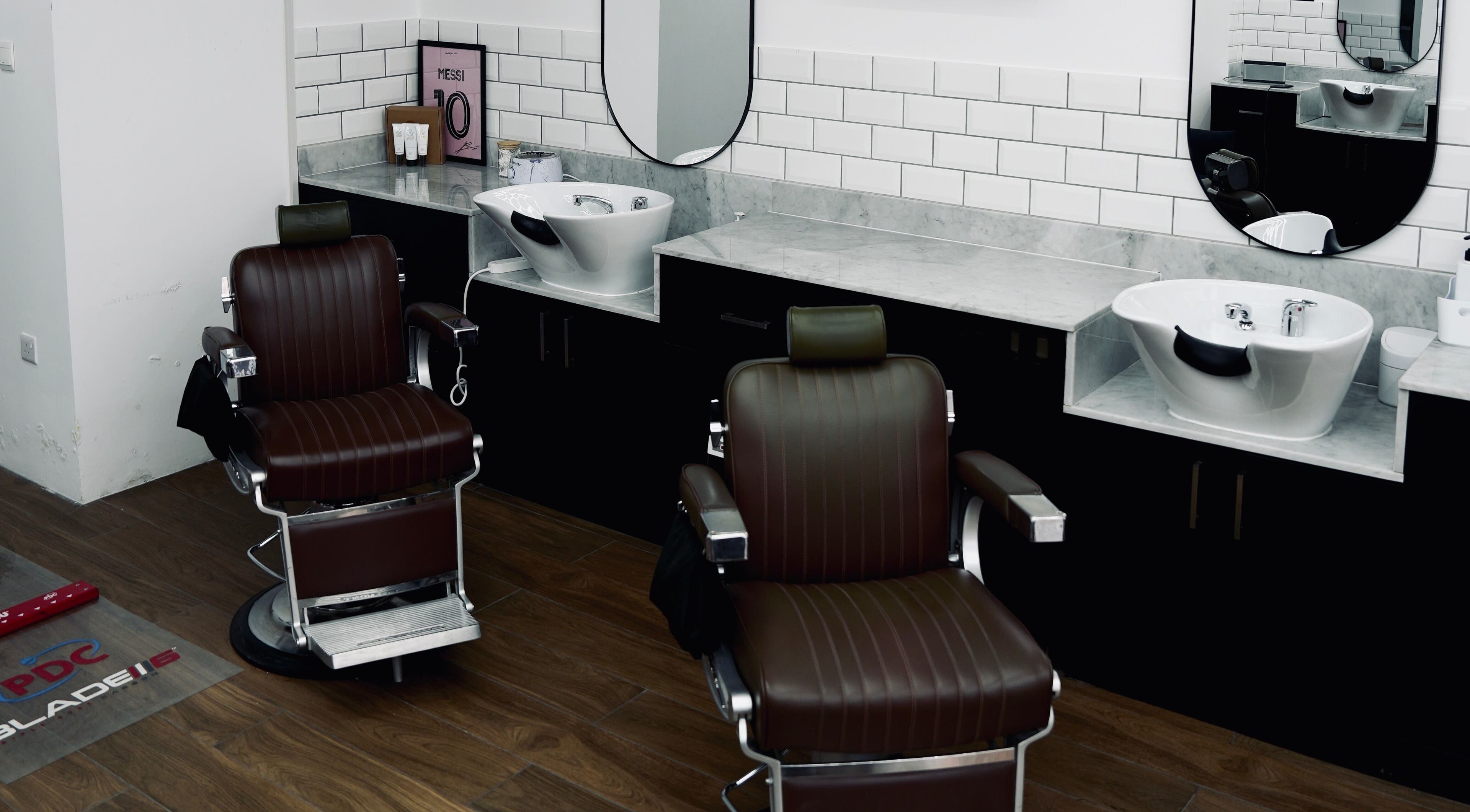 Modern barbershop chairs and washbasins at Plus 44 Barber, Arjan, Dubai, AE, showcasing sleek design.