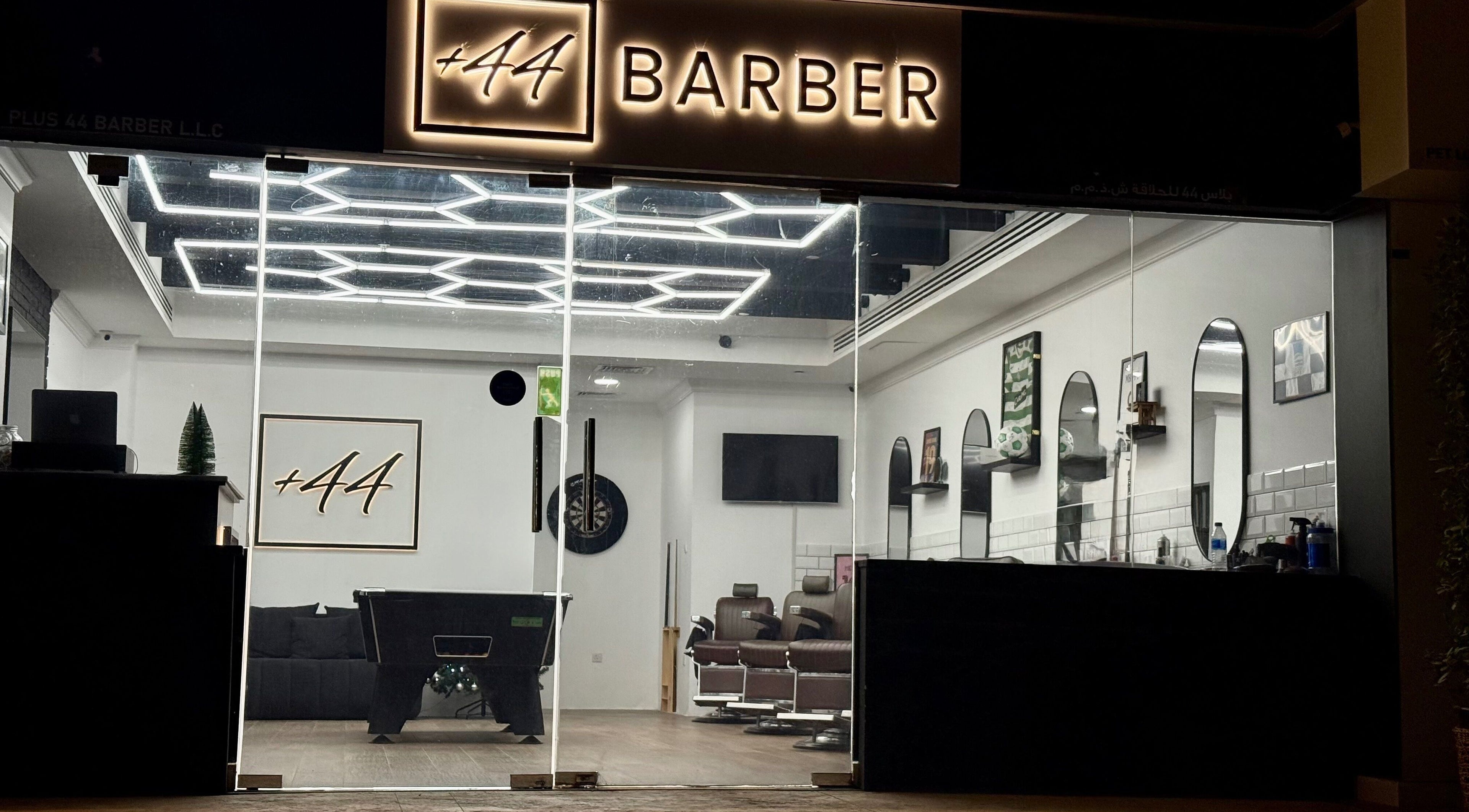 Modern entrance of Plus 44 Barber in Arjan, Dubai, AE, featuring stylish decor and sleek interior design.