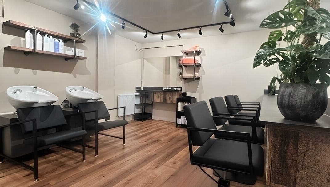 Modern hair salon at Render, Birmingham, England, GB with sleek chairs and washing stations.