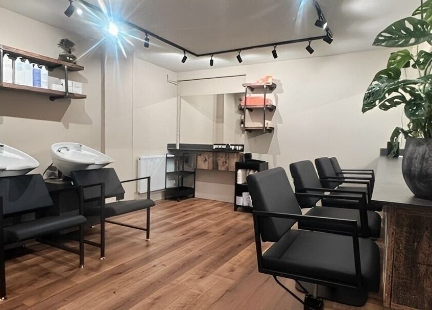 Modern hair salon at Render, Birmingham, England, GB with sleek chairs and washing stations.