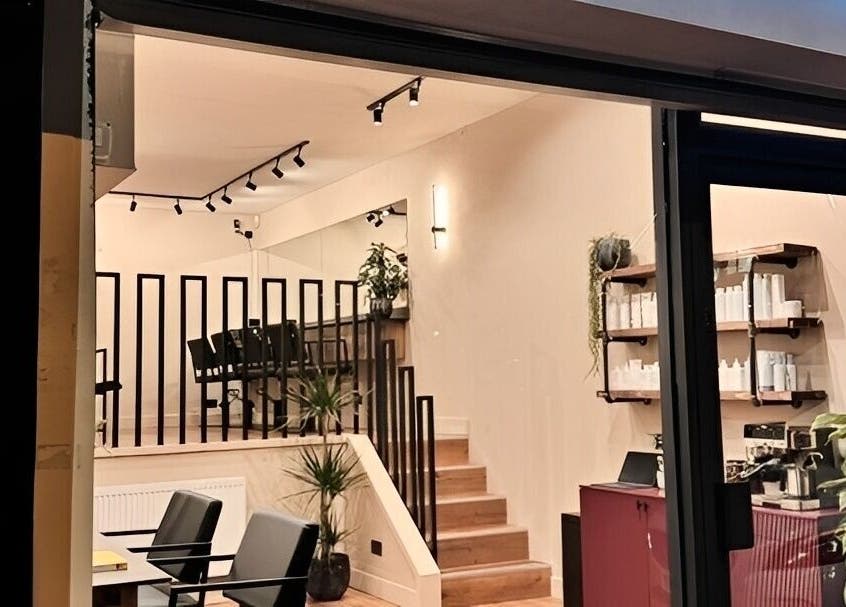 Render salon entrance showcasing modern design with sleek furniture, located in Birmingham, England, GB.