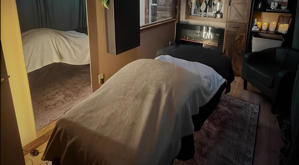 Cozy massage room at Connected LLC, Readfield, Maine, US, featuring a welcoming atmosphere and soft lighting.