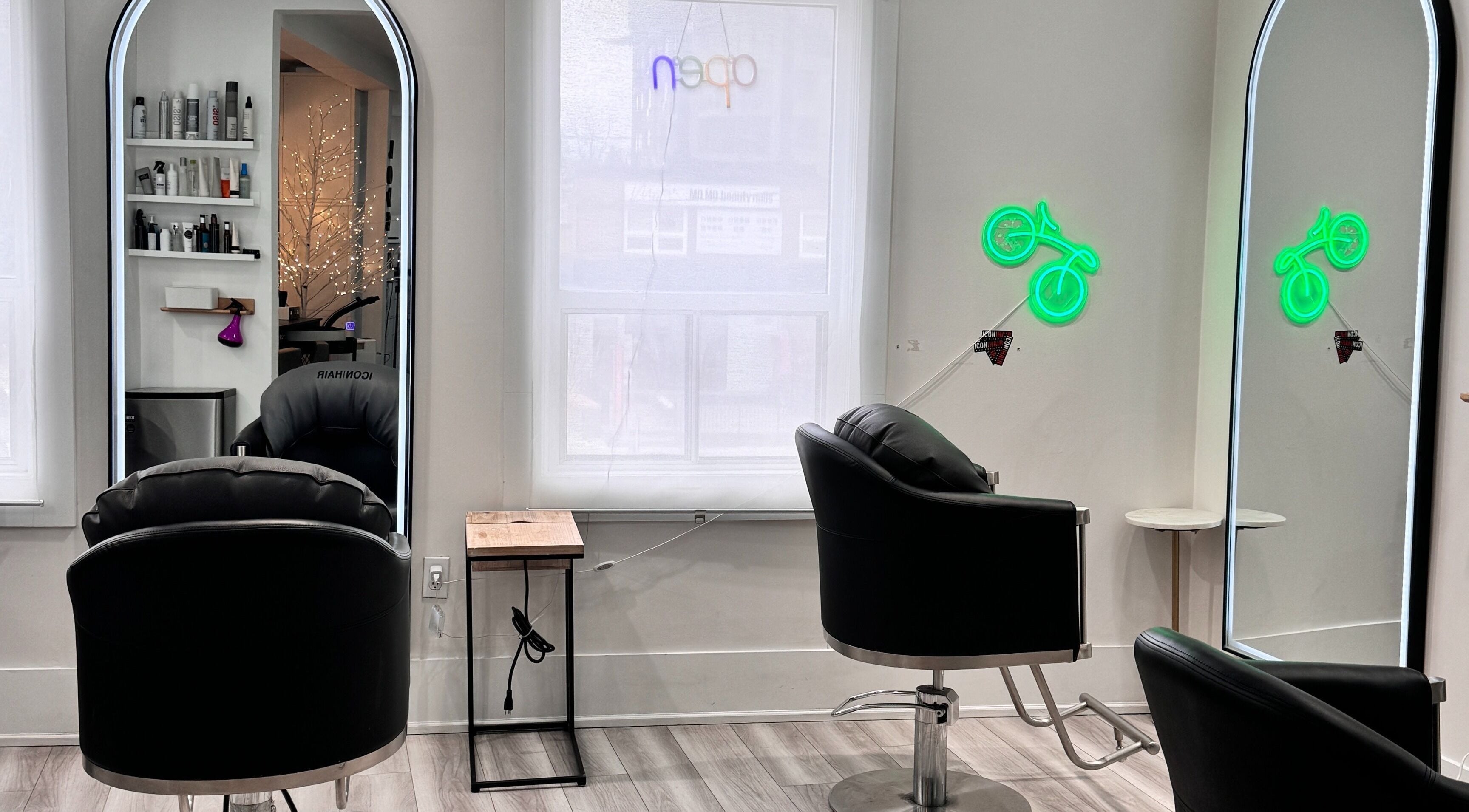Modern salon chairs and mirrors at ICONHAIR in Toronto, Ontario, CA creating a stylish and inviting setting.