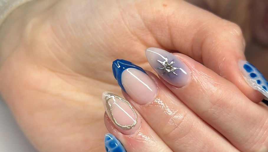 Stylish nail art at Nefarious Nails, Golden Bay, Western Australia, AU, showcasing blue and metallic accents.
