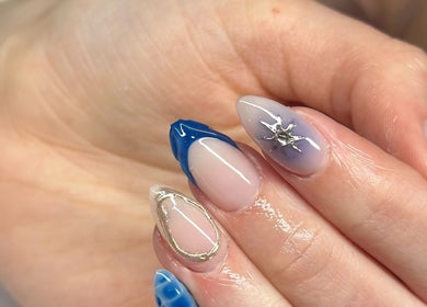 Stylish nail art at Nefarious Nails, Golden Bay, Western Australia, AU, showcasing blue and metallic accents.