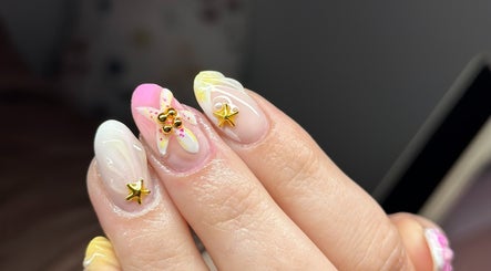 Elegant nail art with gold star and floral designs at Nefarious Nails, Golden Bay, Western Australia, AU.