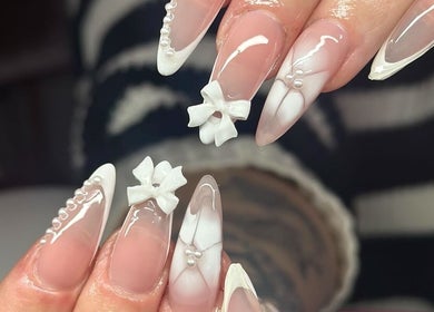 Elegant nail art with bows and pearls at Nefarious Nails, Golden Bay, Western Australia, AU.