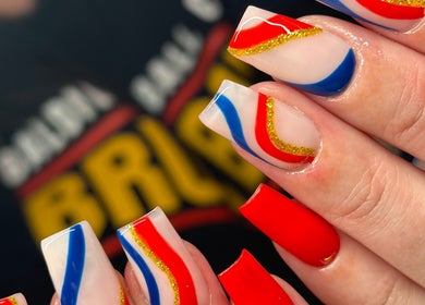 Colorful nail art featuring red, blue, and gold designs at Nefarious Nails, Golden Bay, Western Australia, AU.