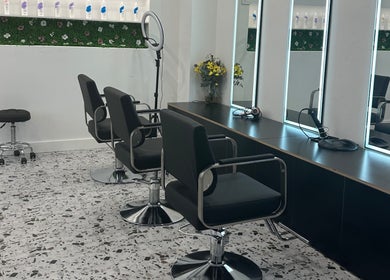 Modern styling chairs at Angel Hair & Lash Studio in Melbourne, Victoria, AU with sleek mirrors and floral decor.
