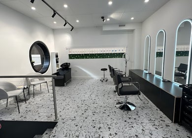 Sleek interior of Angel Hair & Lash Studio, Melbourne, Victoria, AU with modern chairs and mirrors.
